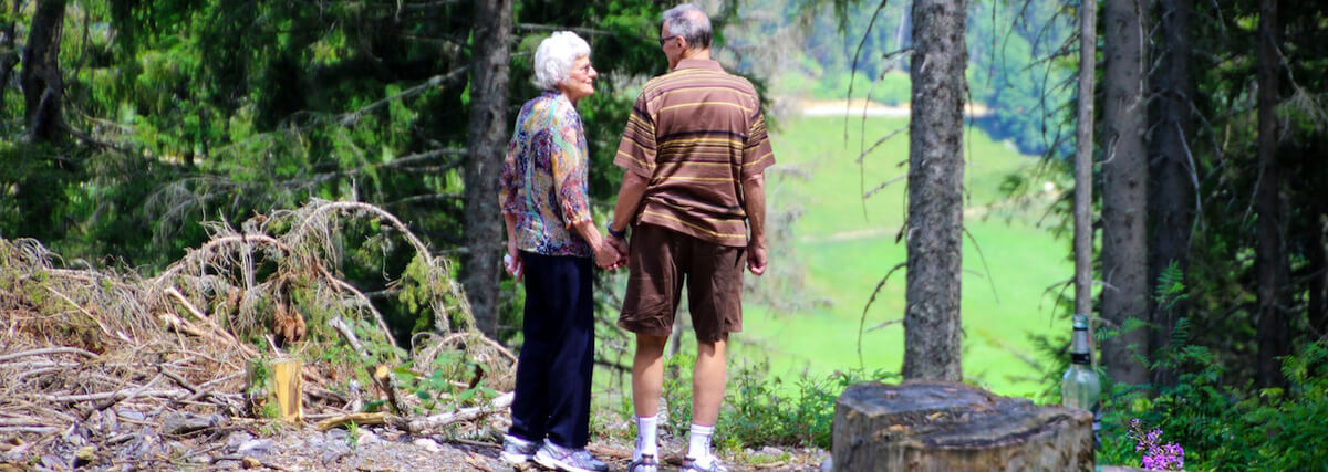 Older couple walking through the woods